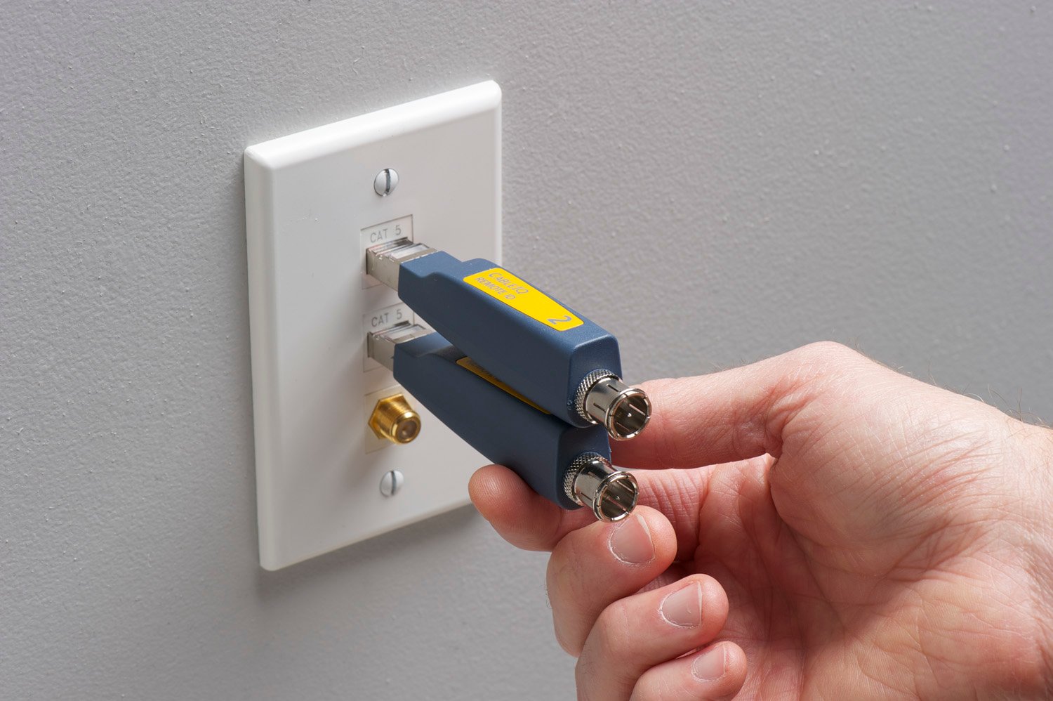 Two remote cable ID sensors plugged into a cable outlet