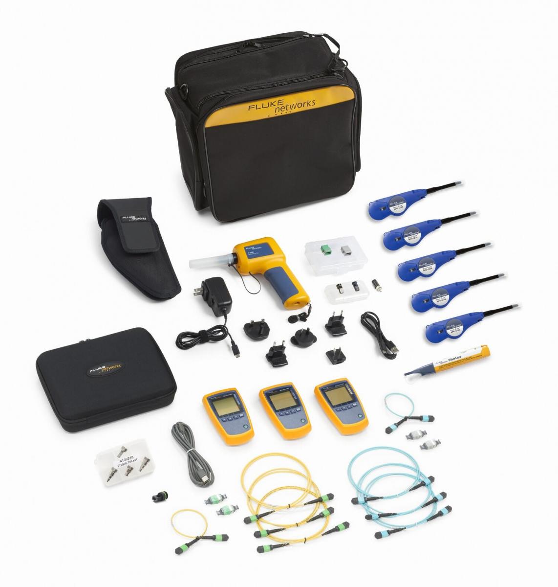 A variety of test devices, cables, and cleaning tools laid out in front of a black carrying case.