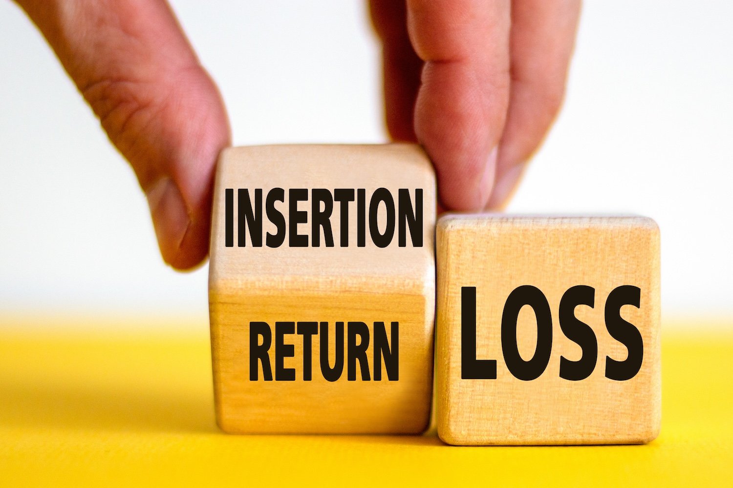 Hand with wooden blocks: one labeled Insertion / Return (at left), the other labeled Loss (at right).